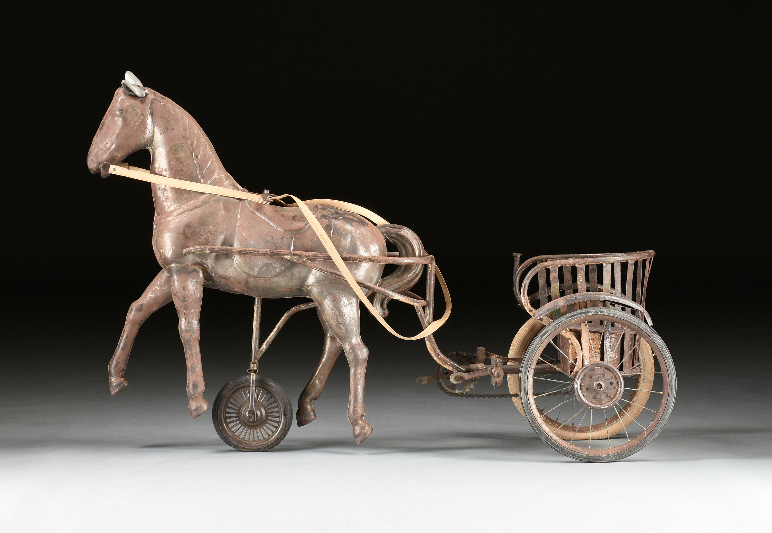 A "SULKY" HORSE DRAWN CHARIOT CHILD'S TIN TRICYCLE, FRENCH, EARLY 20TH CENTURY, modeled as a