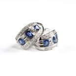 A PAIR OF DE HAGO STYLE 18K WHITE GOLD, DIAMOND, AND SAPPHIRE HUGGIE EARRINGS, MODERN, a cascade