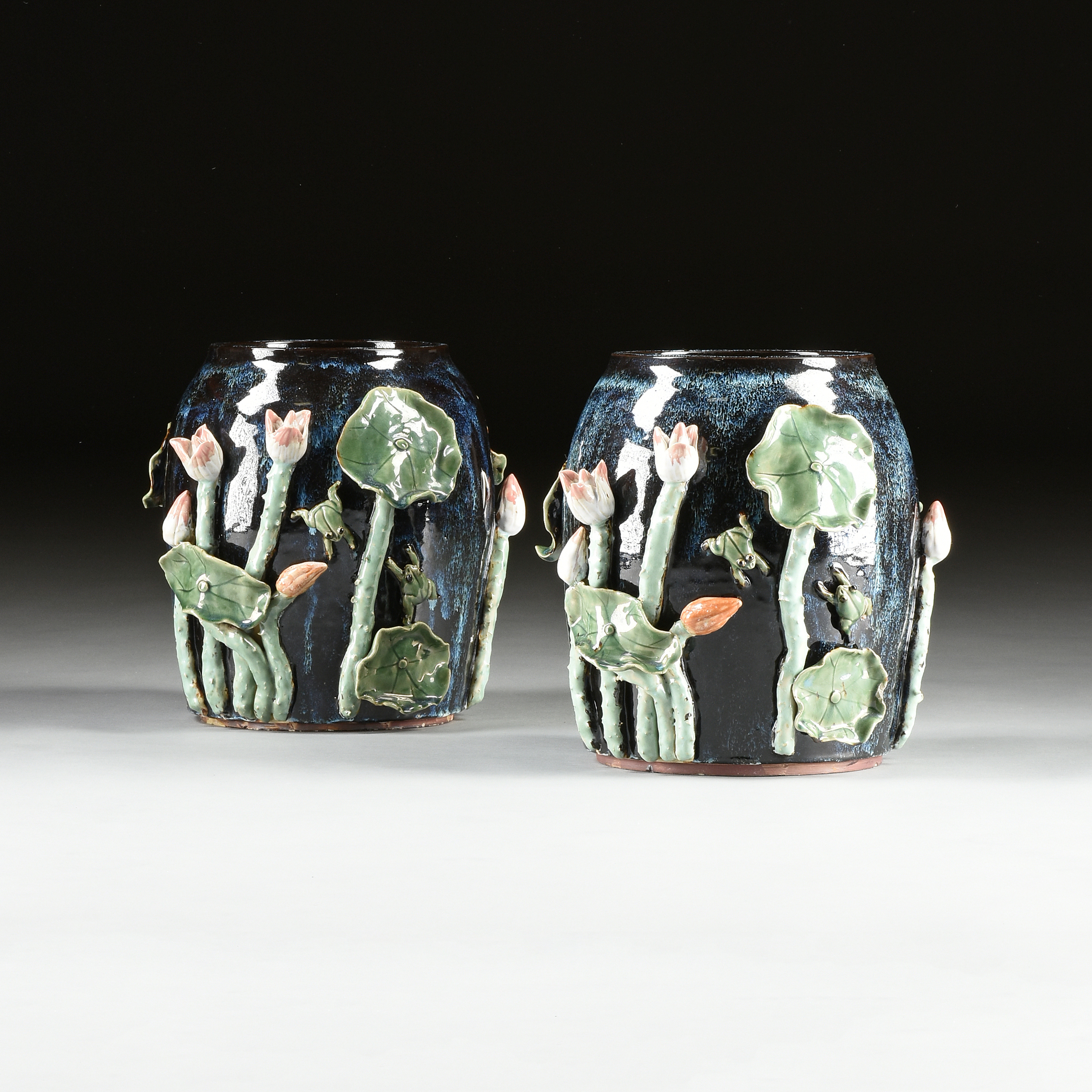 A PAIR OF CHINESE EXPORT RELIEF MOLDED LOTUS AND LEAF GLAZED EARTHENWARE JARDINIÈRES, MODERN,