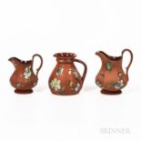 Three Wedgwood Enameled Rosso Antico Jugs