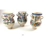 A set of three southern European provinicial pottery jars with 4 handles and naive floral painted