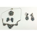 A turquoise and filigree white metal necklace (chain a/f) with matching pair of earrings, plus a