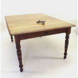 An Edwardian mid oak wind out dining table with two small interleaves all on turned supports