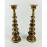 A pair of turned brass candlesticks, 30cm