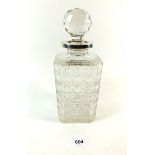 An Edwardian Elkington and Co. cut glass single decanter of square form with silver collar