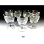 A set of seven cut glass wine glasses