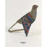 A vintage tin plate mechanical bird toy with flapping wings