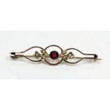 An Edwardian 9ct gold bar brooch set garnets and seed pearls - 2.2g