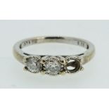 A 9 carat white gold three stone diamond ring, one stone deficient, size M