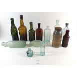 A collection of various glass advertising bottles including Horlicks jar