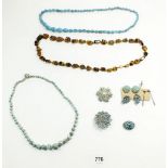 A group of turquoise vintage jewellery and a tigers eye necklace