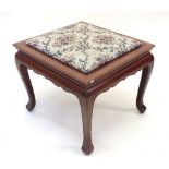 A Chinese hardwood occasional table with reversible stool top
