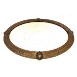 An early 20th century brass framed oval mirror, 65 x 90cm