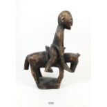 A carved African figure on horseback, 28cm
