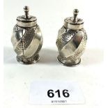 A pair of silver spiral embossed pepper pots, Birmingham 1890 by Cornelius D Saunders and JF