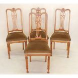 A set of four Edwardian satinwood dining chairs with marquetry interlaced splat back