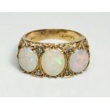 A 9ct gold ring set three large opals flanked by chip diamonds, size L-M, 4.2g