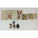 A group of Red Cross badges, boxed