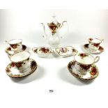 A Royal Albert Country Roses coffee pot, four cups and saucers and two trinket dishes