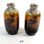 A pair of continental pottery vases with silver rims, painted landscapes, 14cm H