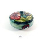 A Moorcroft Hibiscus pattern lidded bowl on a blue ground