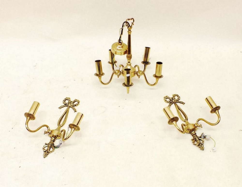 A five branch brass chandelier light fitting and two matching wall lights