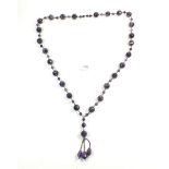 A long amethyst facet cut bead necklace with tassel drop