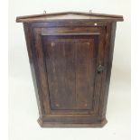 An 18th century mahogany corner wall cupboard with paterae inlay