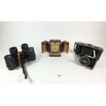 A Kodak Anastigmat camera, Ross binoculars, cased and a Swiza alarm clock