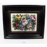 A 19th century Italian micro mosaic plaque of garden flowers in low relief in mahogany frame, plaque