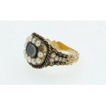 A Georgian black enamel and split pearl set mourning ring with hair panel, size M-N, five pearls