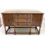 An early 20th century oak Arts & Crafts or Cotswold style sideboard, stamped EG, A Harvey Ltd, 1929,