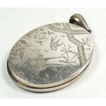 A silver oval locket with engraved stork decoration (hinge a/f) 5cm x 4cm