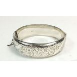 A silver engraved hinged bangle