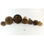 A selection of seven 19thC treen butter stamps