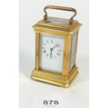A miniature brass eight day carriage clock with key