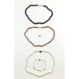 Three freshwater pearl necklaces with silver clasps and a bracelet with gold clasp