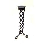 A cast iron floorstanding candlestick