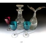 A glass oil and vinegar, cut glass decanter, two blue wine glasses and a cranberry one