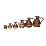 A set of five 19th century graduated copper jugs