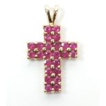 A 9ct gold ruby set crucifix pendant, 2cm