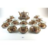 A Royal Crown Derby Imari part set of twelve coffee cups and eleven saucers, four tea plates, one