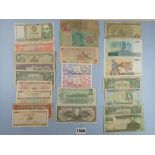 A wad of North & South America banknotes. Examples including: Argentina, Canada, Cuba, Brazil,