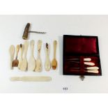 A collection of bone spoons etc and a bone handled sewing set, boxed
