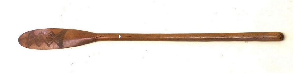 A wooden tribal paddle oar with engraved geometrical design. Possibly Indonesian in origin