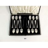 A set of twelve silver coffee spoons and tongs, cased, Sheffield 1933 - 117g