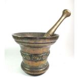 A large 17th or early 18th century bronze pestle and mortar, the mortar with band of shell and