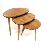 A retro Ercol elm nest of three pebble occasional tables