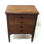 An Edwardian mahogany music cabinet of four drop front drawers