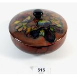 A Moorcroft flambe lidded bowl painted in the orchid pattern